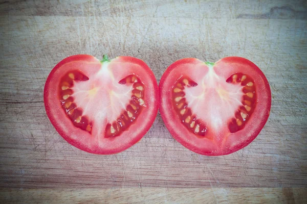 Half cut of red tomato in heart shape — Stock Photo, Image