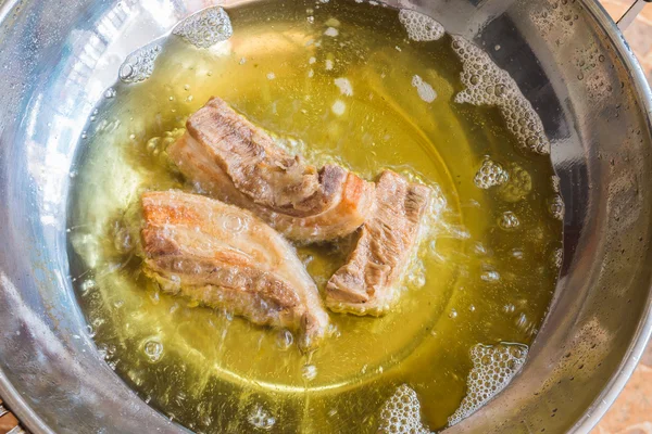 Frying crispy pork in hot oil — Stock Photo, Image