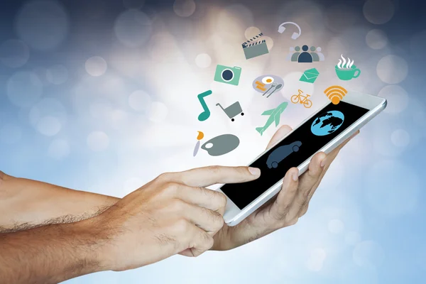 Geschäftsmann hält digitales Tablet in der Hand, verschiedene Symbole erscheinen — Stockfoto
