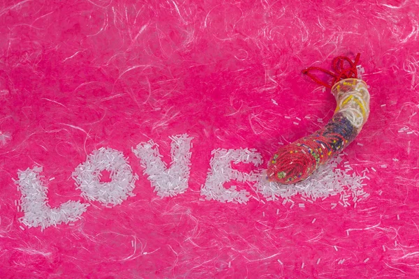 Love wording arrange by bead with thread bead in condom — Stock Photo, Image