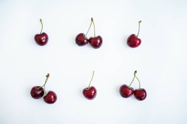 ripe red cherries on a white background. pattern of ripe red cherries on a white background. healthy food 