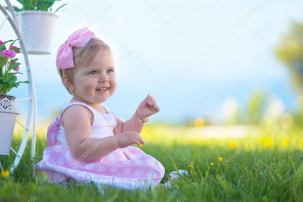Happy smiling baby girl playing outside