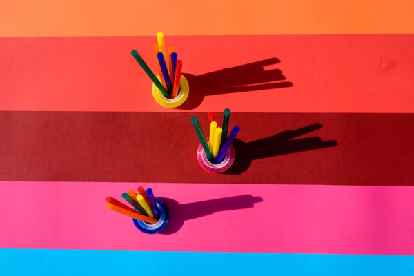 Colored background seen from above with plastic bars to use in crafts and stationery.