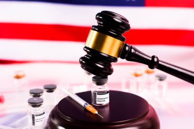 The covid vaccine is legal in the United States and has not committed a crime, vial threatened with gavel. clipart