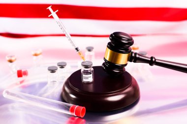 The covid vaccine is legal in the United States and has not committed a crime, vial threatened with gavel. clipart