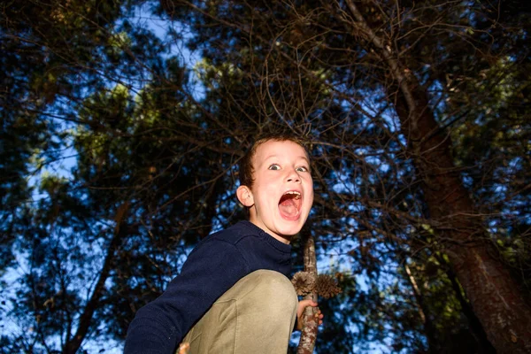 Scared child screams in fear, lost in a dark forest.