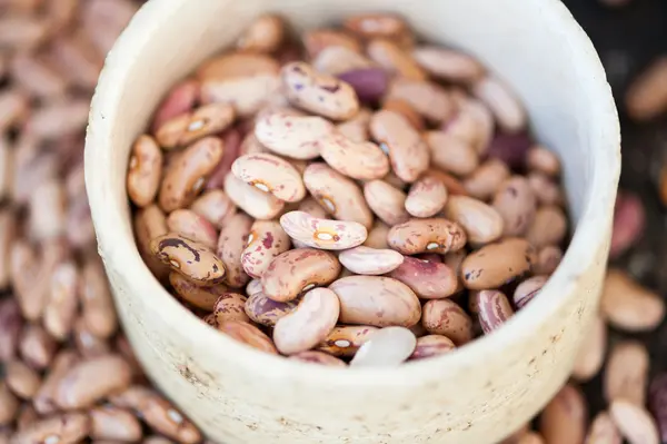 Brown beans on a black background — Stock Photo, Image