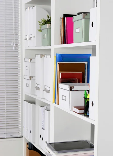 Bookcase with folders Royalty Free Stock Photos