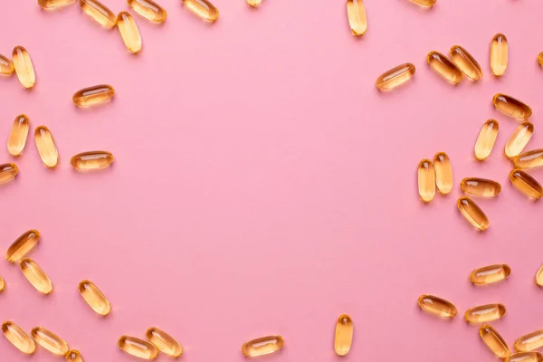 Vitaminler Omega 369 balık yağı, D vitamini. Telif alanı üst görüşlü, sağlık yaşam tarzı için pembe arka planda.