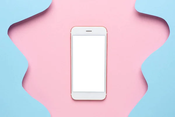 Mobile phone and Abstract paper cut blue waves art on pink background, pastel colors and technology top view