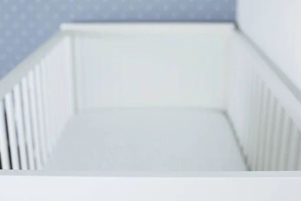 Baby bed crib white color in white bedroom side view without kid side view