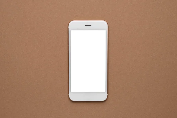 Mobile phone with white screen on a light brown background. Trend, minimal concept with copyspace top view