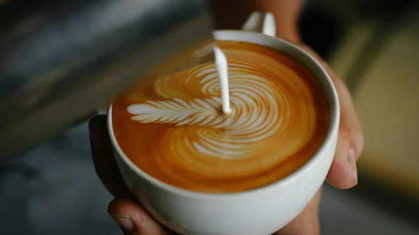 Coffee latte art in coffee shop vintage color tone — Stock Photo, Image