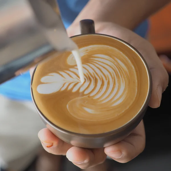 Coffee latte art in coffee shop vintage color tone — Stock Photo, Image