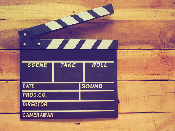 clapper board on wood background vintage color tone