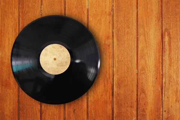 Vinyl record in wood background — Stock Photo, Image