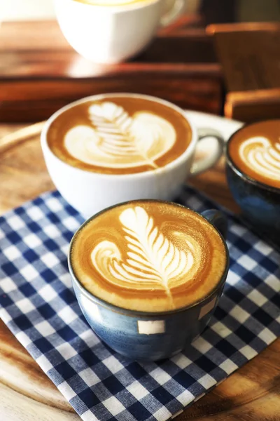 Винтажный тон чашки кофе с красным сердцем на столе — стоковое фото