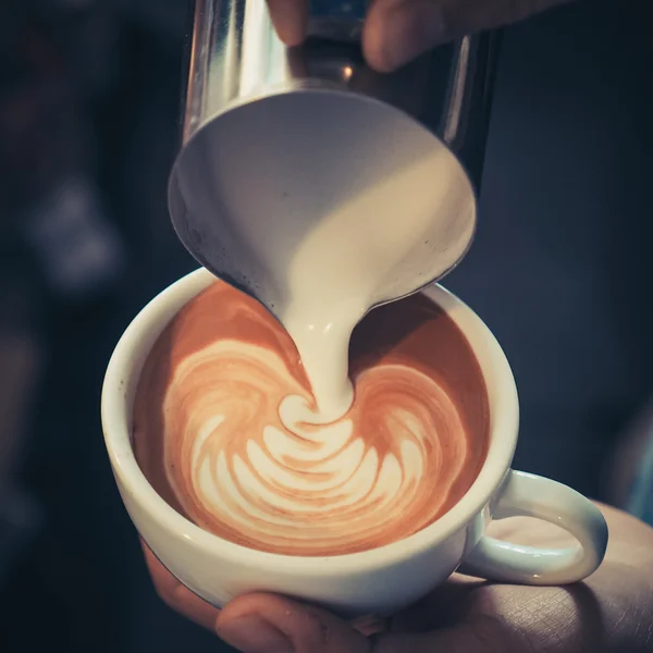 Cup 的咖啡拿铁艺术木在复古色调背景上 — 图库照片