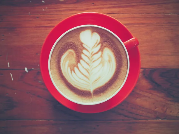 Cup of coffee on the wooden desk — Stock Photo, Image