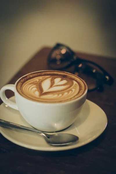 Coffee latte art on the wood desk — Stock Photo, Image