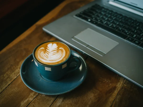 Cup of coffee latte on the wood texture — Stock Photo, Image