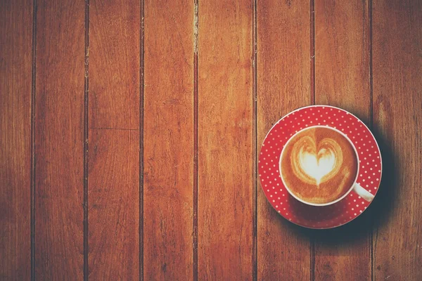 Cup of coffee on the wooden desk — Stock Photo, Image