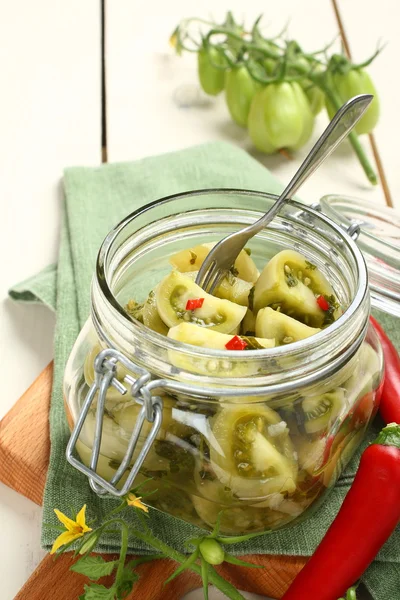 Homemade green tomatoes preserves in glass jar — Stock Photo, Image