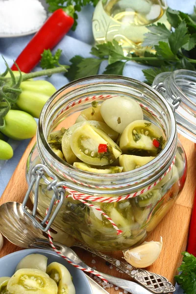 Glass jar with pickled green tomatoes prepared for winter — Stock Photo, Image