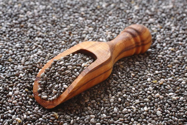 Chia seeds in wooden scoops, one of the superfoods — Stock Photo, Image