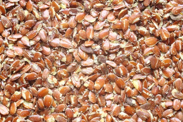 Top view of broken flax seeds. Может использоваться в качестве фона — стоковое фото