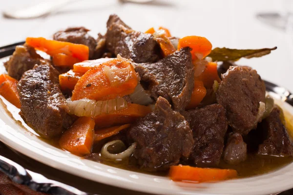 Plate of beef stroganoff with carrot — Stock Photo, Image