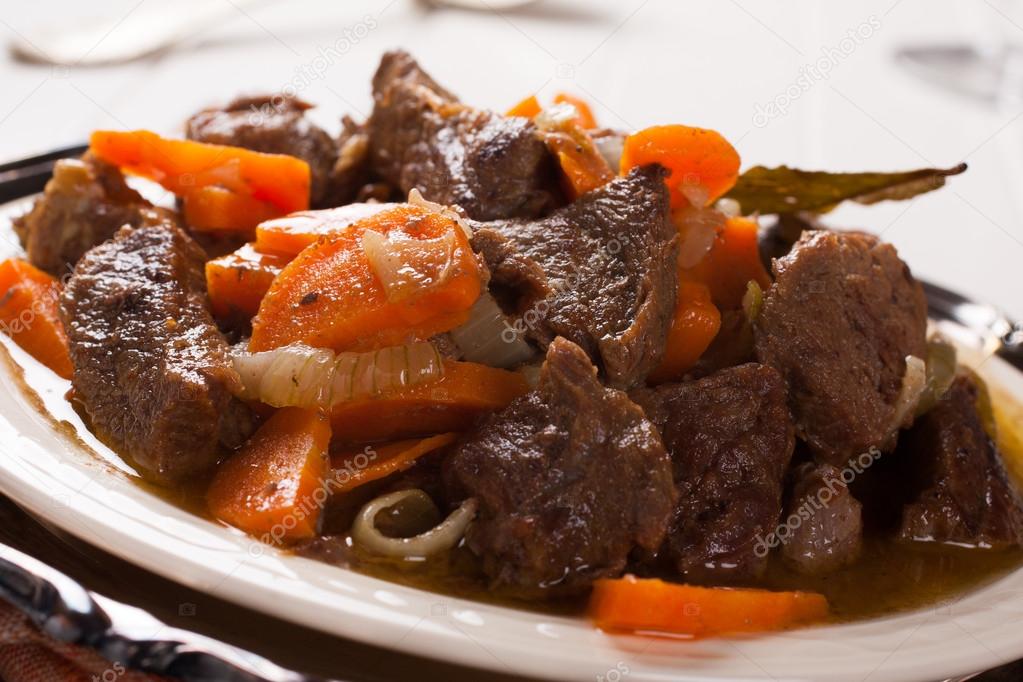 Plate of beef stroganoff with carrot