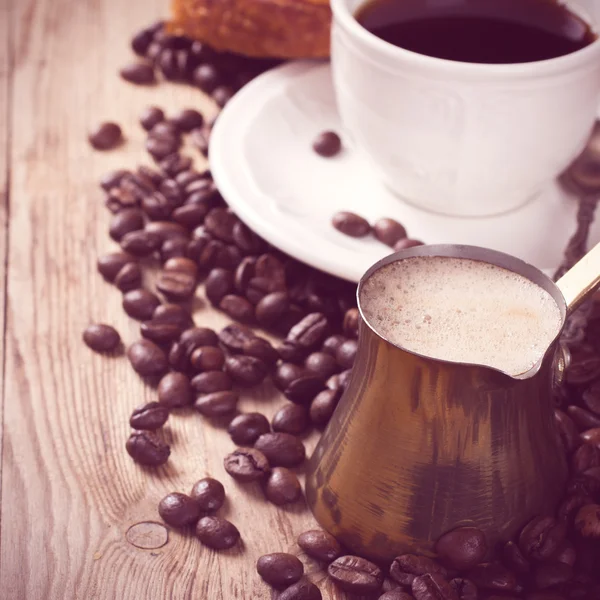 Vecchia caffettiera e tazza su sfondo rustico in legno — Foto Stock