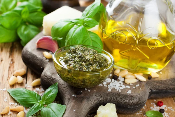 Homemade pesto on a rustic wooden cutting board. — Stock Photo, Image