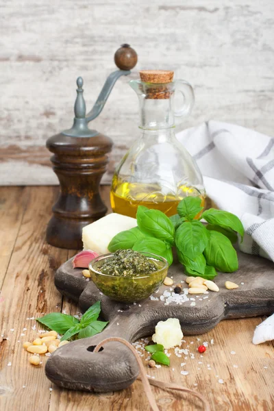 Homemade pesto on a rustic wooden cutting board. — Stock Photo, Image