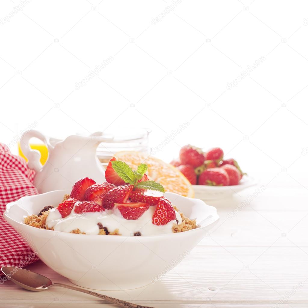 Yogurt with granola and fresh strawberries