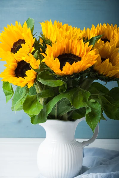 Beautiful sunflowers bouquet in white vase — Stock Photo, Image