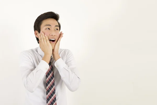 Happy and amazed asian young man touching his face — Stock Photo, Image