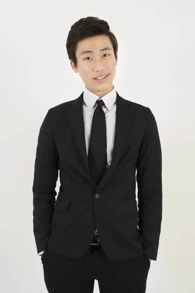 Asian young man in a black suit — Stock Photo, Image