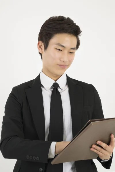 Ung asiatisk forretningsmand med en fil - Stock-foto