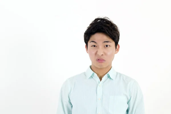 Frowning asian male student — Stock Photo, Image