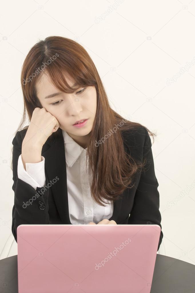 Stressed asian businesswoman with laptop