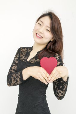 Kırmızı kalp ile gülümseyen Asyalı kadın