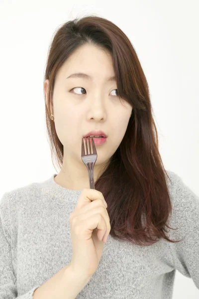 Attractive asian woman with fork — Stock Photo, Image