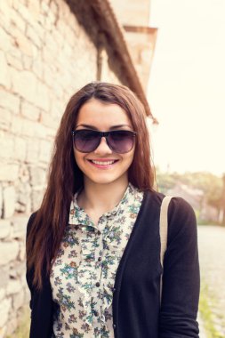 sunny portrait of a woman with glasses