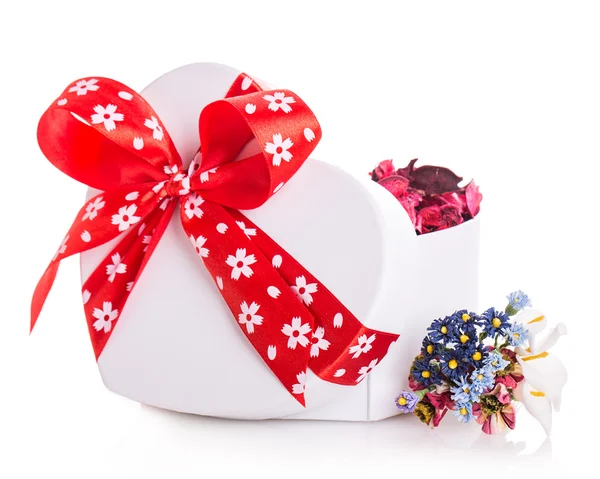 Gift box ribbon red heart with flower petals — Stock Photo, Image