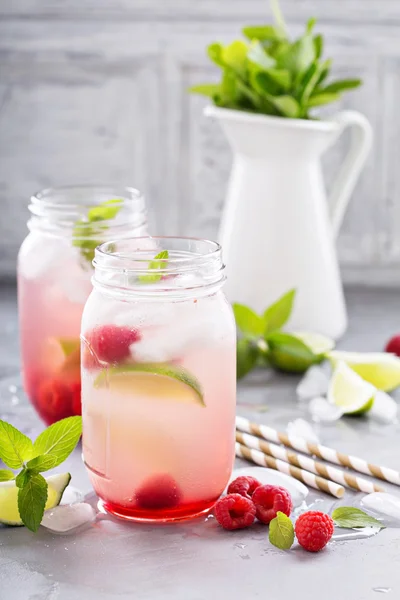 Cold green iced tea with lime and raspberry — Stock Photo, Image