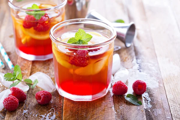 Red summer cocktail with lemons and raspberry — Stock Photo, Image