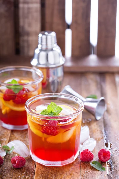 Red summer cocktail with lemons and raspberry — Stock Photo, Image