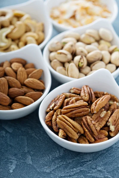 Variety of nuts in small bowls — Stock Photo, Image